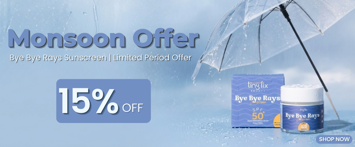 Monsoon Offer advertisement for Bye Bye Rays sunscreen, featuring a blue and white 15% off discount banner, a clear umbrella with raindrops, and the blue product box and jar on a light blue water-textured background.